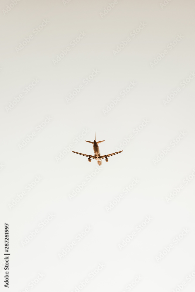 Airplane flying in the sky at sunset. Travel, vacation and holiday concept. Vintage and retro tones filter. Airplane flying in the sky at sunset. Travel, vacation and holiday concept. Vintage and retro tones filter.