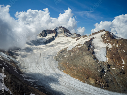 Mountain top view of Glacier Senales partly covered in clouds photo