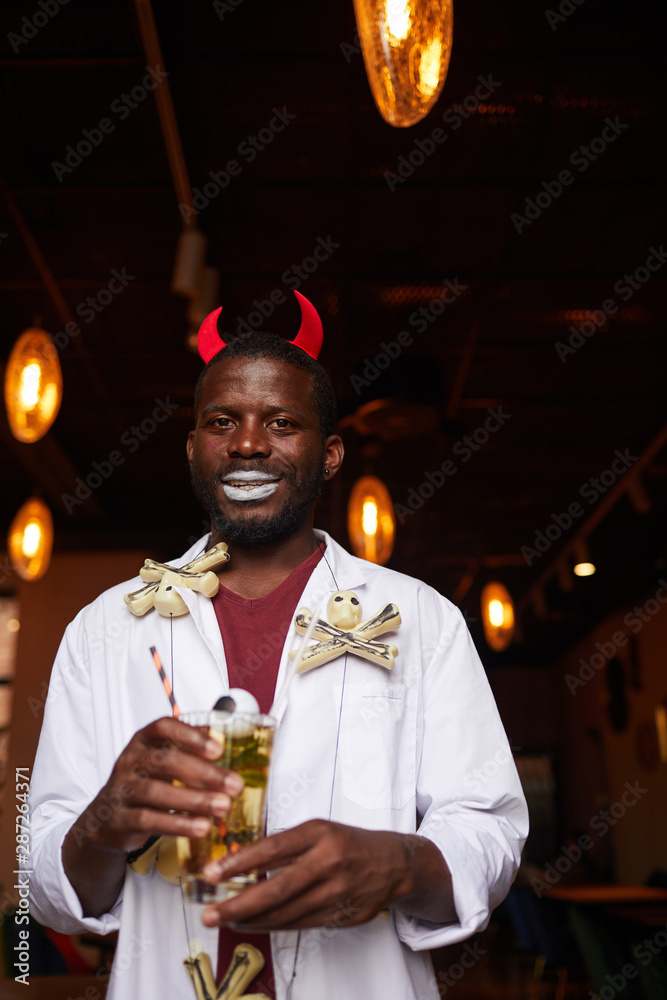 Waist up portrait of African-American man wearing Halloween costume posing  with drink during party in night club, copy space Stock Photo | Adobe Stock