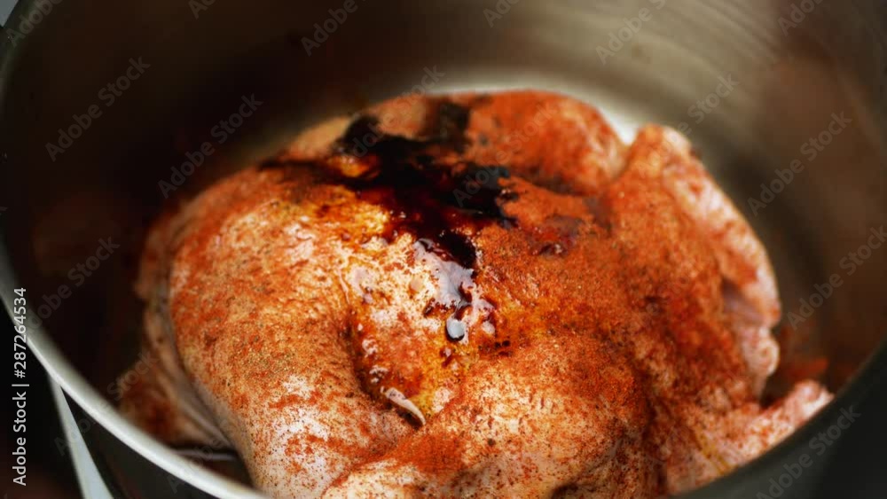 Chicken is marinated with seasonings and sauces in a saucepan Chicken is marinated with seasonings and sauces in a saucepan