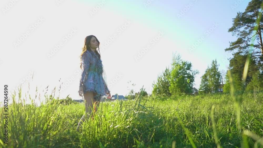 beautiful young girl model is spinning on the nature in the field without makeup beautiful young girl model is spinning on the nature in the field without makeup