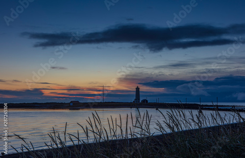 Canvas-taulu Grotta Island Lighthouse, located off the Atlantic Ocean coast near the city of Reykjavik, Iceland, at sunset