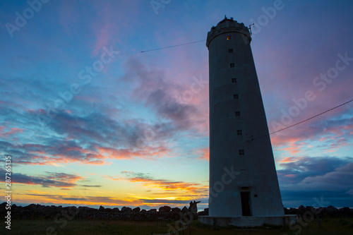 Grotta Island Lighthouse, located off the Atlantic Ocean coast near the city of Reykjavik, Iceland, at sunset.