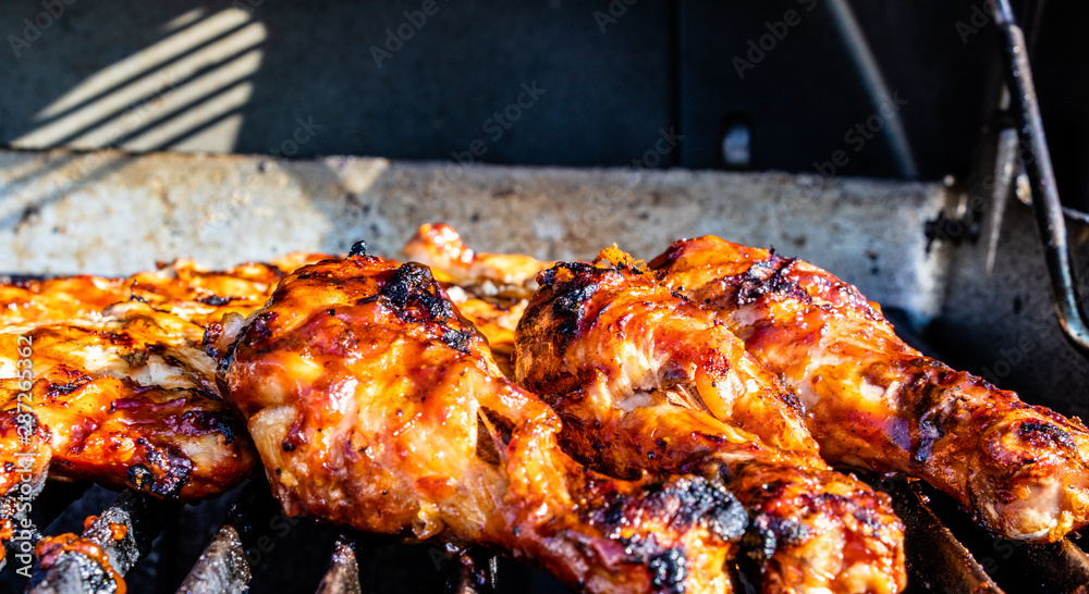 BBQ sauced Chicken legs and breasts on the grill. Calgary, Alberta, Canada