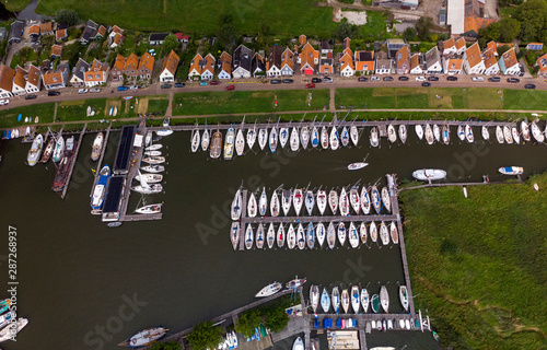 Top down aerial view of marine port area for pleasure boats and sailboats with typical houses of the Dutch village of Durgerdam near Amsterdam