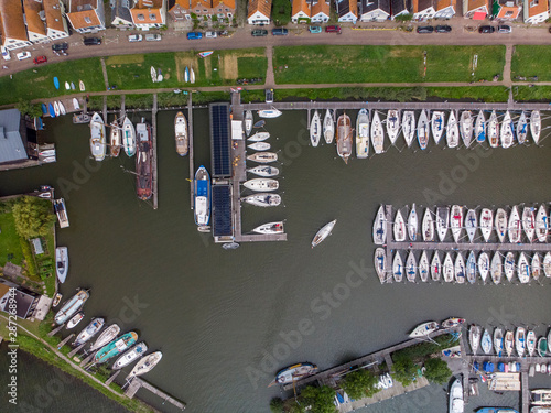Top down aerial view of marine port area for pleasure boats and sailboats with typical houses of the Dutch village of Durgerdam near Amsterdam