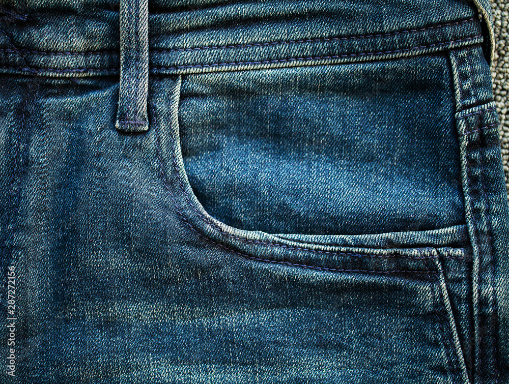 Denim blue jeans stack texture background closeup.