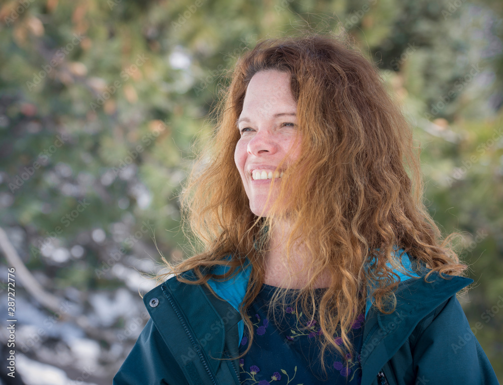 Portrait smiling pretty red hair middle aged woman outdoors in snow Portrait smiling pretty red hair middle aged woman outdoors in snow