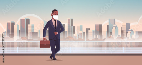 businessman wearing face mask toxic gas air pollution industry smog danger polluted environment concept african american business man walking outdoor cityscape skyline full length horizontal
