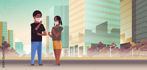 couple wearing face masks toxic gas air pollution industry smog polluted environment concept man woman walking outdoor dirty smoke skyscrapers cityscape skyline background full length horizontal