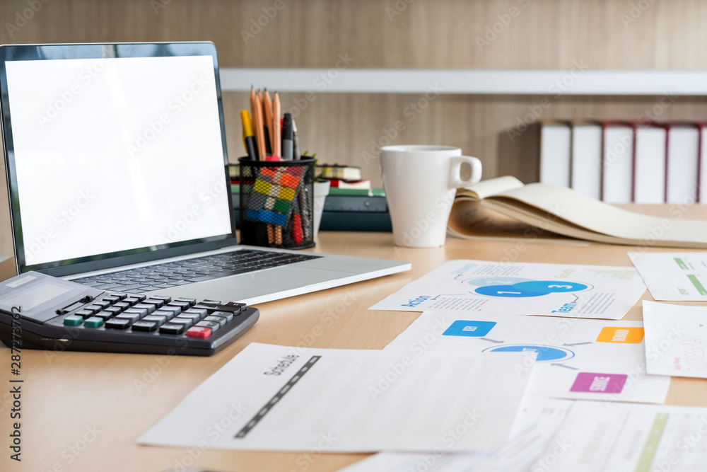 mockup laptop computer screen with business chart market,caculator,coffee cup,pencil box on desk at brick wall at modern office meeting room.device template for display of design.clipping path screen mockup laptop computer screen with business chart market,caculator,coffee cup,pencil box on desk at brick wall at modern office meeting room.device template for display of design.clipping path screen
