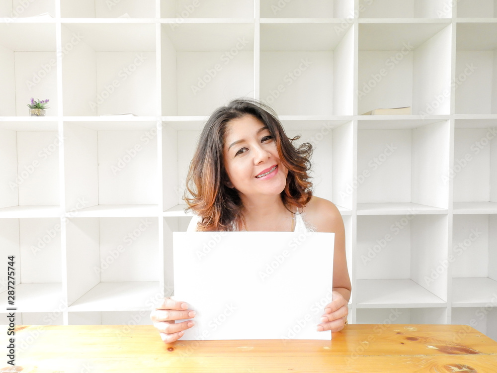 Attractive beautiful woman holding blank white paper. Attractive beautiful woman holding blank white paper.