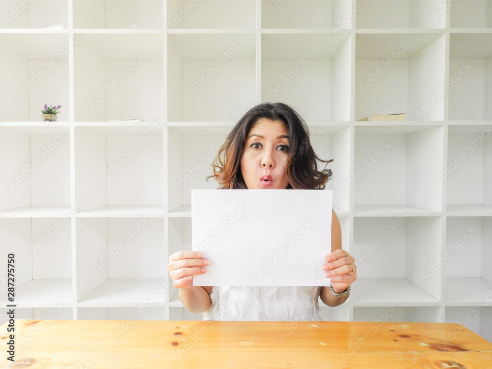 Attractive beautiful woman holding blank white paper. Attractive beautiful woman holding blank white paper.