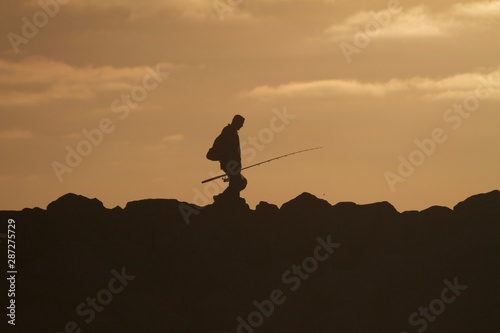 fisherman finishing for the day sepia sunset moody sunset rocky point