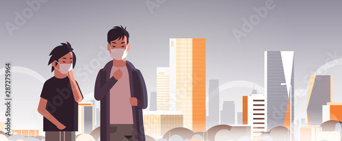 two men wearing face masks environmental industrial smog dust toxic air pollution virus protection concept guys walking outdoor city building cityscape skyline background portrait horizontal