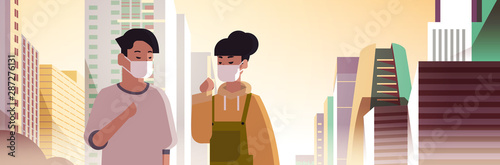 couple wearing face masks toxic gas air pollution industry smog polluted environment concept man woman walking outdoor dirty smoke skyscrapers cityscape skyline background portrait horizontal