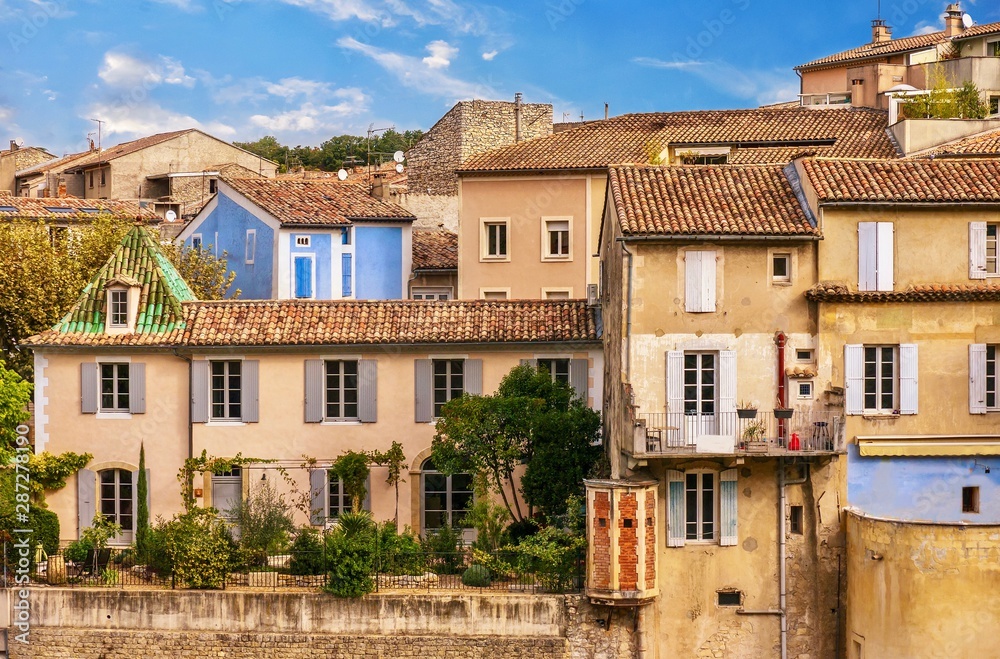 Street view of a picturesque residential neighborhood in the lower city area of Vaison-La-Romaine in Provence, France.