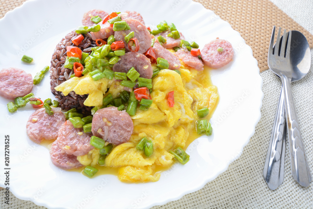 Fermented Pork Sausage Omelet with eggs and chilies, this dish would be delicious by fried in large amount of hot oil. Fermented Pork Sausage Omelet with eggs and chilies, this dish would be delicious by fried in large amount of hot oil.