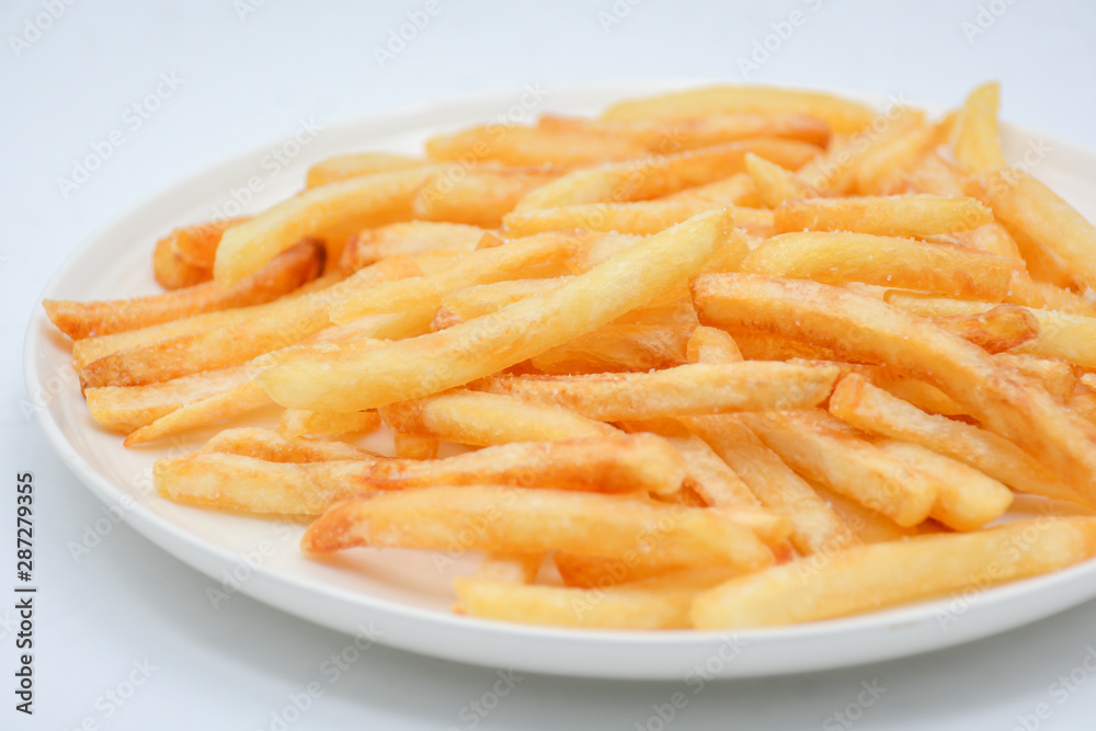 French fries on white dish and white background.
