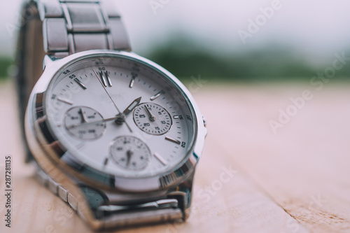 Close up hand watch Time clock on wood table