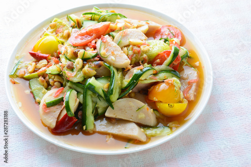 Cucumber salad with preserved pork sausages, Thai popular food called Som Tum Tang, Hot and spicy, mixed vegetables.