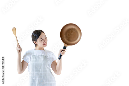 Asian pretty girl's portrait in cooking and chef concept close up. Asian woman holding a wooden flipper and modern pan. Isolated on white background.