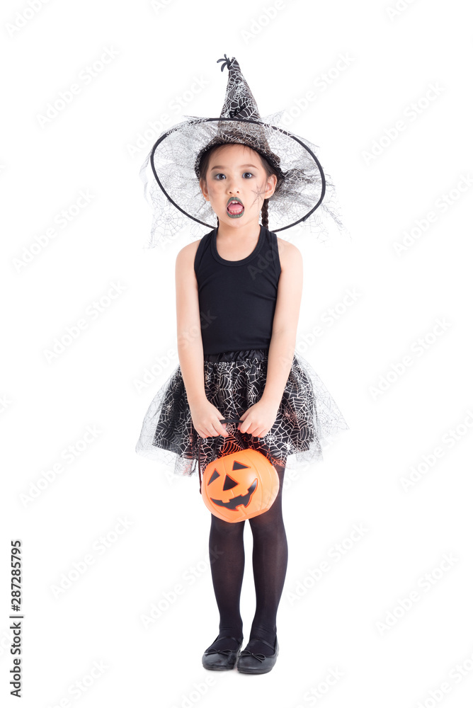 Full length of little asian pretty girl in witch costume standing and  holding halloween pumpkin bucket over white background Stock Photo | Adobe  Stock