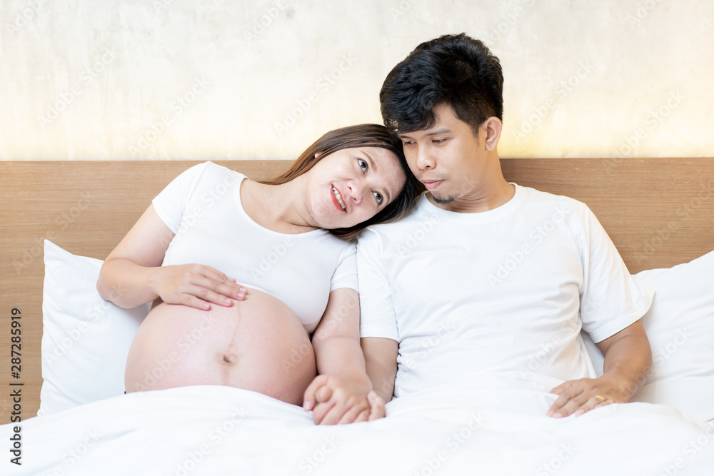 Pregnant woman and her hasband holding their hands together. Concept of happy family and good quality of life. Pregnant woman background. Pregnant woman and her hasband holding their hands together. Concept of happy family and good quality of life. Pregnant woman background.
