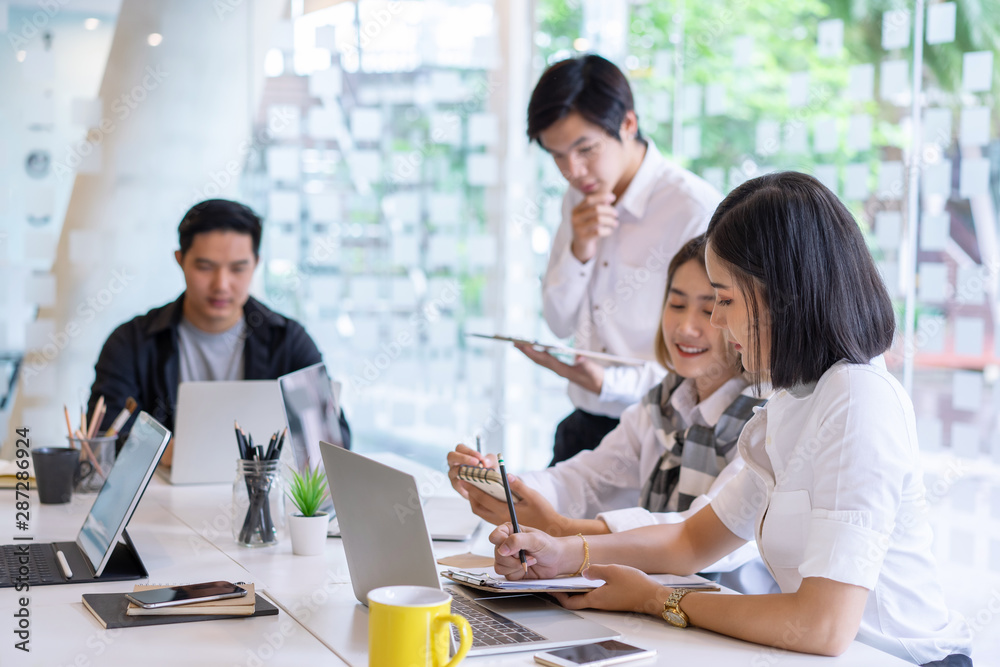 Group of asian diverse university students concentrated on study or working together with laptop at a university. indoor Group of asian diverse university students concentrated on study or working together with laptop at a university. indoor