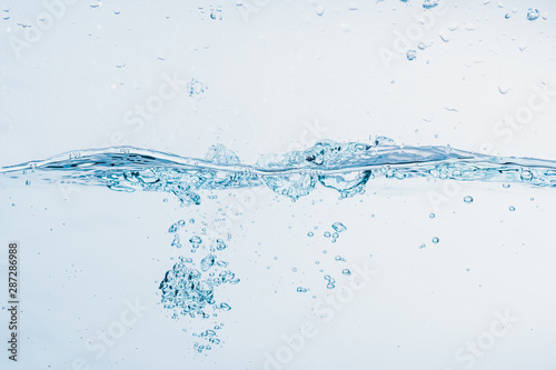 Water splash close up of splash of water forming shape isolated on white background.