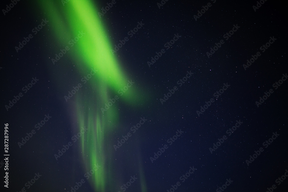 Aurora Borealis / Northern Lights / Nordlys in night sky over Tromso, Arctic Norway