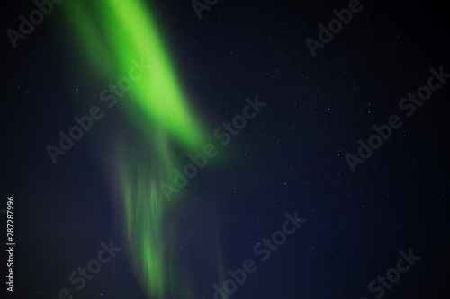 Fototapeta Naklejka Na Ścianę i Meble -  Aurora Borealis / Northern Lights / Nordlys in night sky over Tromso, Arctic Norway