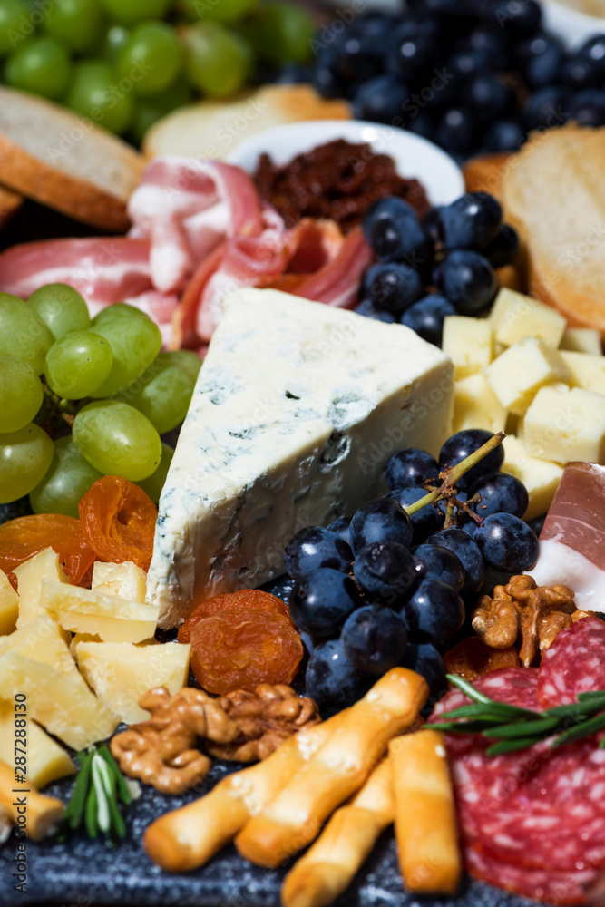 assorted gourmet cheeses and meats, vertical closeup assorted gourmet cheeses and meats, vertical closeup