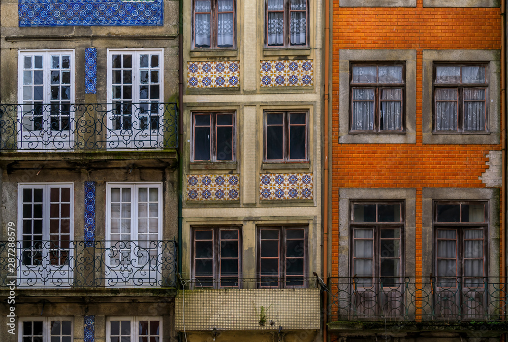 Facades of traditional houses decorated with ornate Portuguese azulejo tiles in Porto, Portugal Facades of traditional houses decorated with ornate Portuguese azulejo tiles in Porto, Portugal