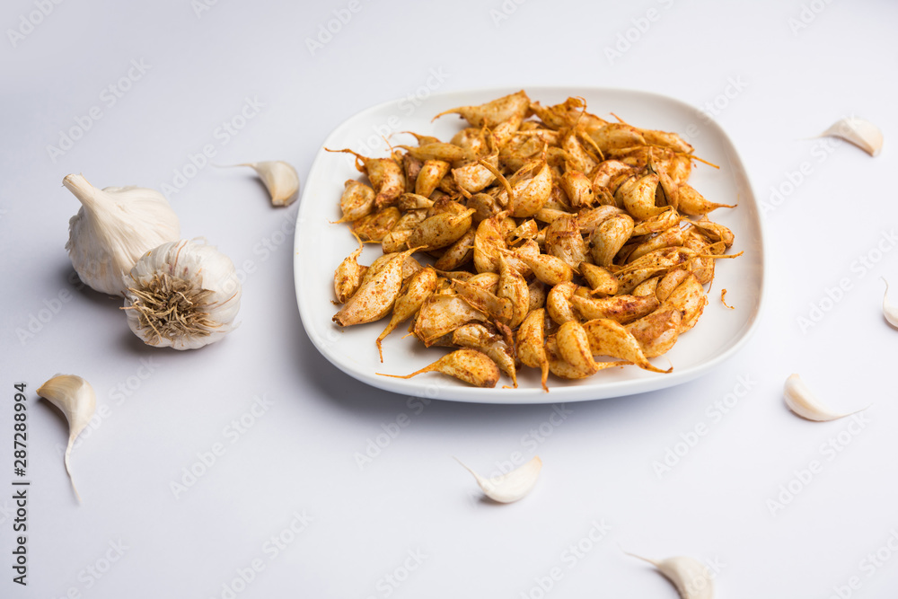 Garlic Fry or Tala Hua Lahsun in hindi, is a popular side dish or snacks from maharashtra, India Garlic Fry or Tala Hua Lahsun in hindi, is a popular side dish or snacks from maharashtra, India