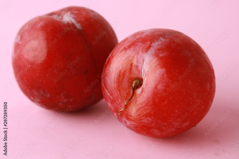 Delicious plums in colorful background