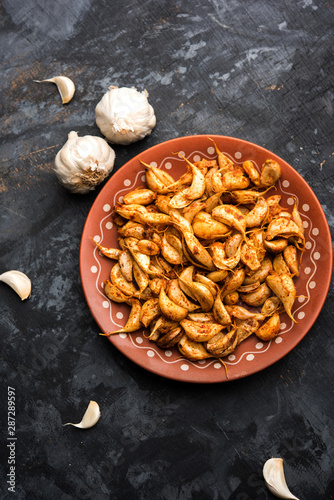 Garlic Fry or Tala Hua Lahsun in hindi, is a popular side dish or snacks from maharashtra, India photo