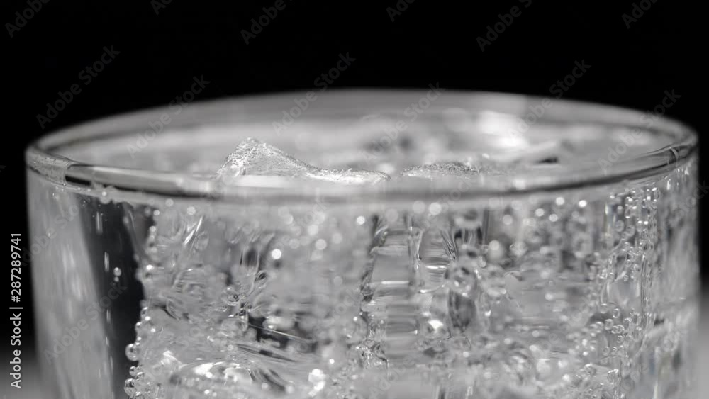 ice and soda water with bubbles on black background ice and soda water with bubbles on black background
