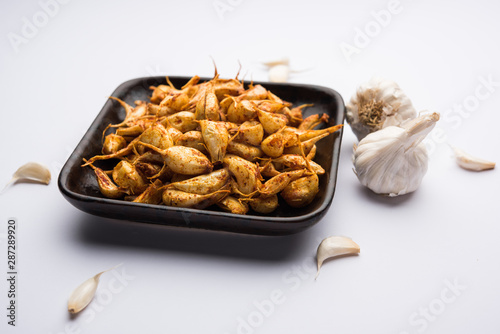 Garlic Fry or Tala Hua Lahsun in hindi, is a popular side dish or snacks from maharashtra, India photo