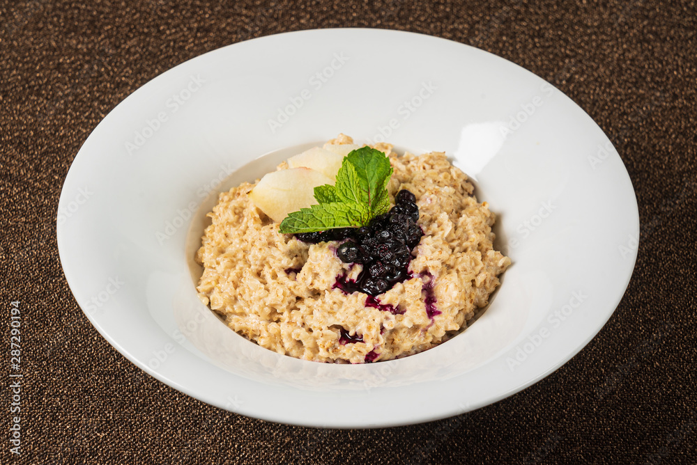Bowl of oatmeal porridge with berry sauce Bowl of oatmeal porridge with berry sauce