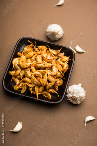 Garlic Fry or Tala Hua Lahsun in hindi, is a popular side dish or snacks from maharashtra, India photo