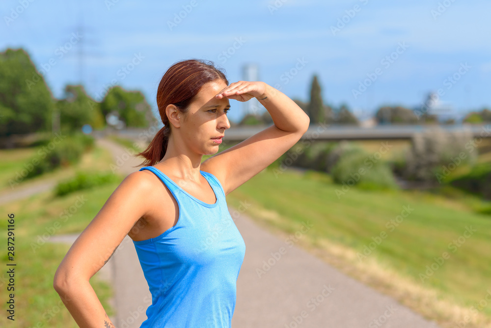 Attractive tanned woman standing watching Attractive tanned woman standing watching