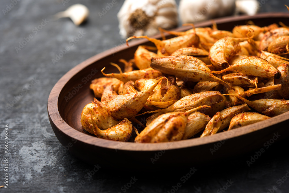 Garlic Fry or Tala Hua Lahsun in hindi, is a popular side dish or snacks from maharashtra, India Garlic Fry or Tala Hua Lahsun in hindi, is a popular side dish or snacks from maharashtra, India