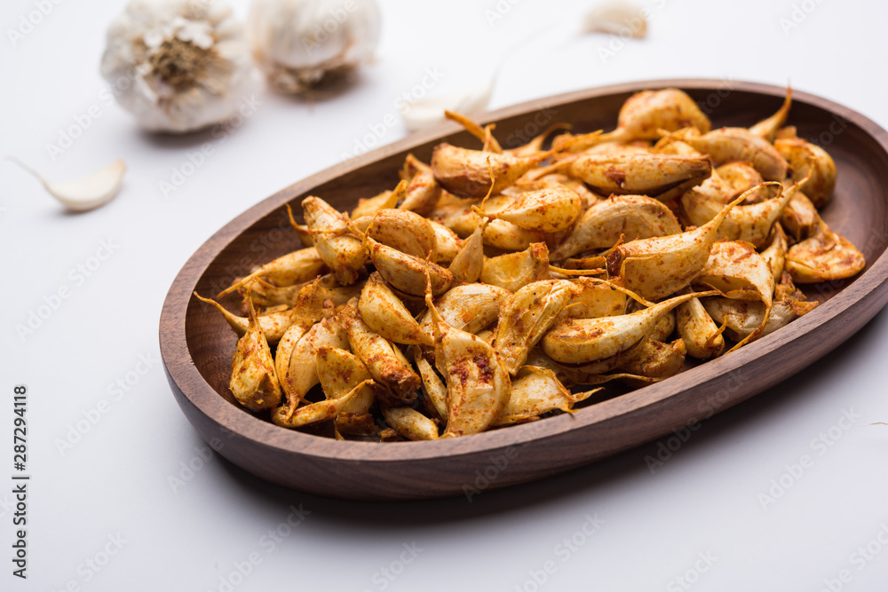 Garlic Fry or Tala Hua Lahsun in hindi, is a popular side dish or snacks from maharashtra, India Garlic Fry or Tala Hua Lahsun in hindi, is a popular side dish or snacks from maharashtra, India