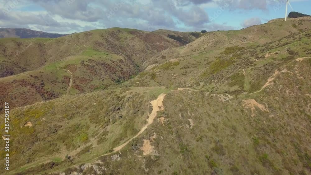 Overhead view of the green hills and hiking trails in Makara, New Zealand Overhead view of the green hills and hiking trails in Makara, New Zealand