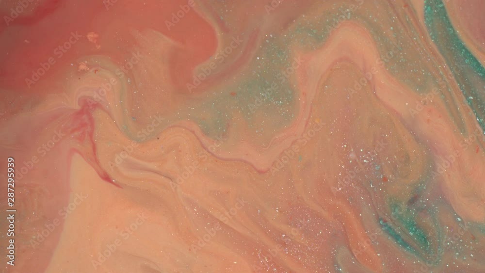Close up of peach glitter texture background. Pastel coral, blue and pink colors liquid paint. Abstract fluid makeup composition. Hypnotic mixing and movement of the ink