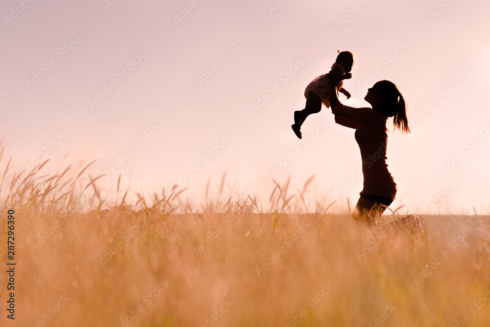 Mother playing with her baby outdoor, silhouette. Mother playing with her baby outdoor, silhouette.
