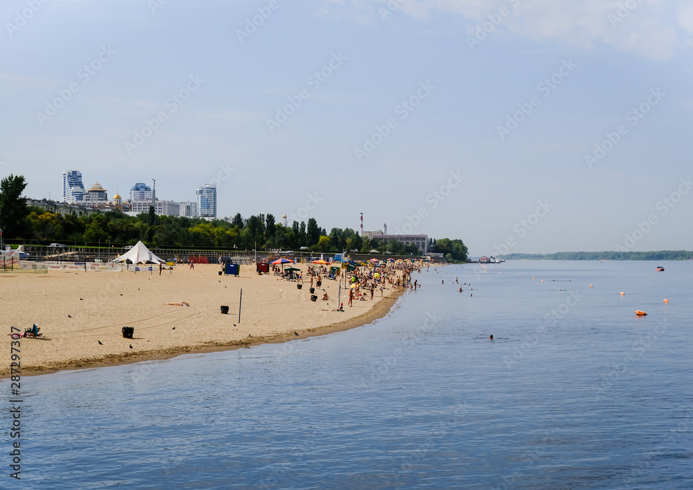 Summer beach on the waterfront of the city