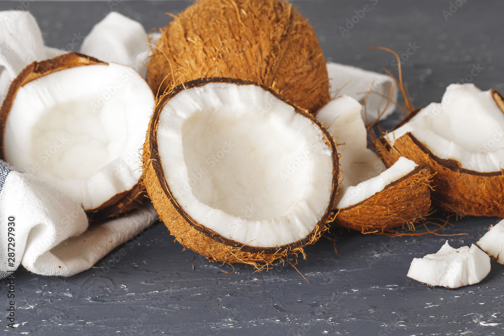 Pile of broken coconuts on ripped grey background Pile of broken coconuts on ripped grey background