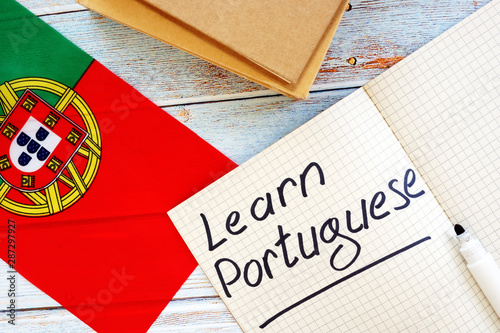 Learn Portuguese language concept. Flag and notebooks. photo